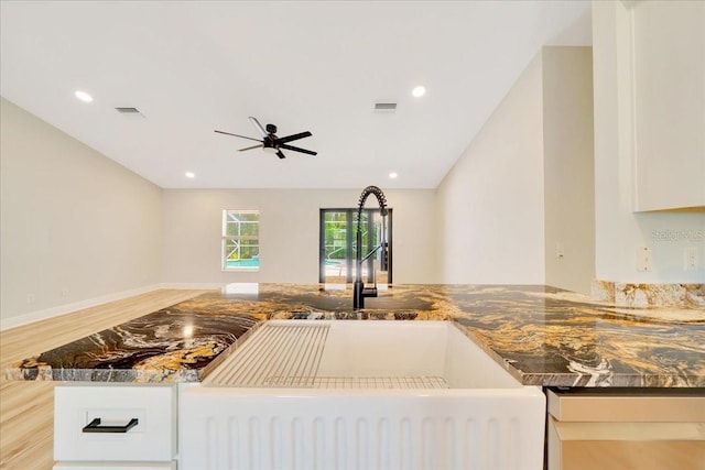 6631 SE 11th Loop, Ocala, FL 34472 - kitchen featuring ceiling fan, dark stone counters, recessed lighting, white cabinets, and wood finished floors