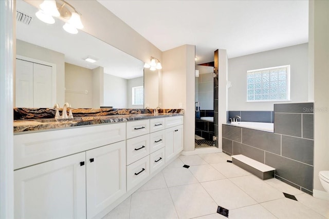 6631 SE 11th Loop, Ocala, FL 34472 - bathroom with double vanity, healthy amount of natural light, a garden tub, and a stall shower