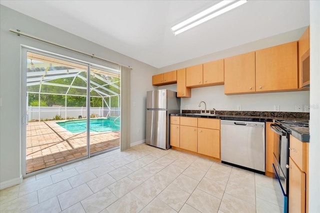 6631 SE 11th Loop, Ocala, FL 34472 - kitchen featuring stainless steel appliances, a sunroom, dark countertops, and light brown cabinetry