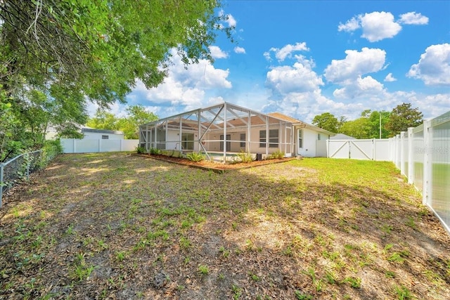 6631 SE 11th Loop, Ocala, FL 34472 - back of house with a fenced backyard, glass enclosure, and a gate