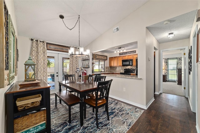 501 Marion Oaks Dr, Ocala, FL 34473 - dining room with dark wood-type flooring, french doors, a chandelier, a textured ceiling, and lofted ceiling