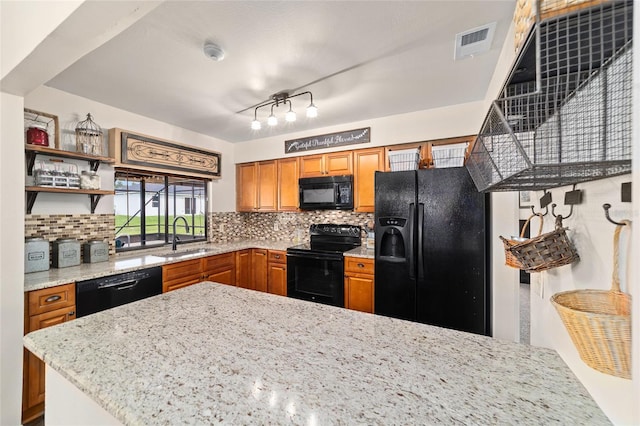 501 Marion Oaks Dr, Ocala, FL 34473 - kitchen with black appliances, brown cabinets, and backsplash