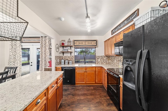 501 Marion Oaks Dr, Ocala, FL 34473 - kitchen with black appliances, tasteful backsplash, dark wood-type flooring, light stone countertops, and french doors