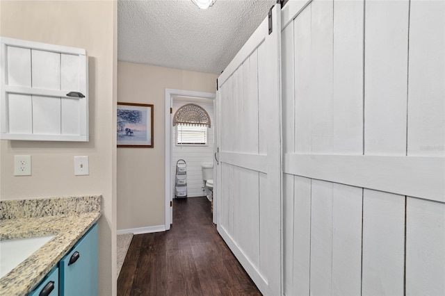 501 Marion Oaks Dr, Ocala, FL 34473 - corridor featuring dark wood-style flooring and a textured ceiling