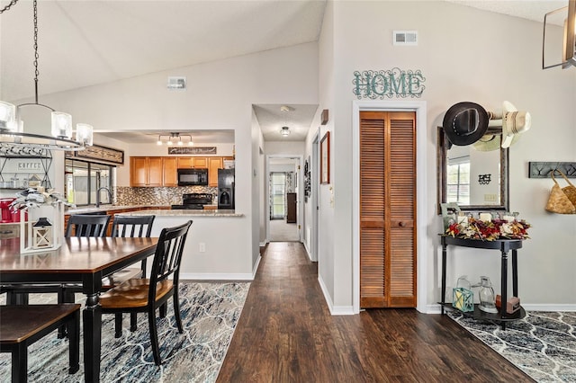 501 Marion Oaks Dr, Ocala, FL 34473 - dining area featuring lofted ceiling, dark wood-style flooring, healthy amount of natural light, and a chandelier