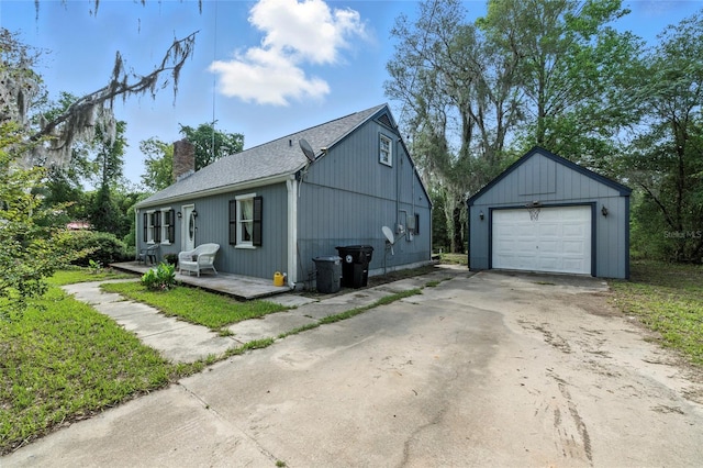 5693 Payette Ave, Keystone Heights, FL 32656 - view of side of property with a chimney, an outdoor structure, driveway, a detached garage, and roof with shingles