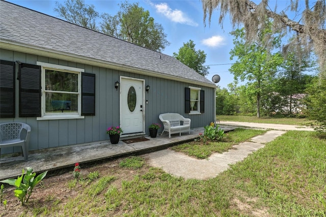 5693 Payette Ave, Keystone Heights, FL 32656 - property entrance featuring a shingled roof and a yard