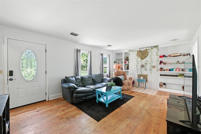 5693 Payette Ave, Keystone Heights, FL 32656 - living area with plenty of natural light, hardwood / wood-style floors, and built in features