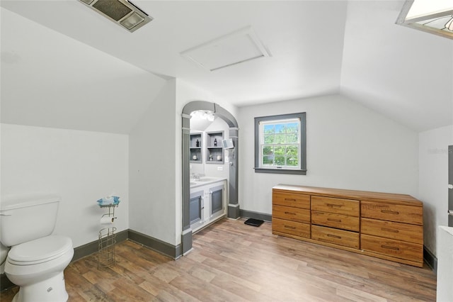 5693 Payette Ave, Keystone Heights, FL 32656 - bathroom with vaulted ceiling, vanity, and wood finished floors