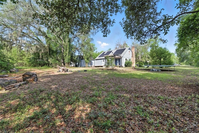 5693 Payette Ave, Keystone Heights, FL 32656 - view of grassy yard with a trampoline