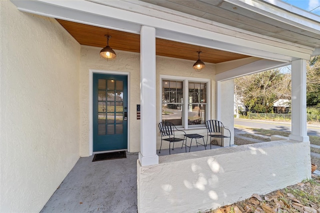 114 NE 11th Ave, Ocala, FL 34470 - doorway to property with stucco siding and covered porch