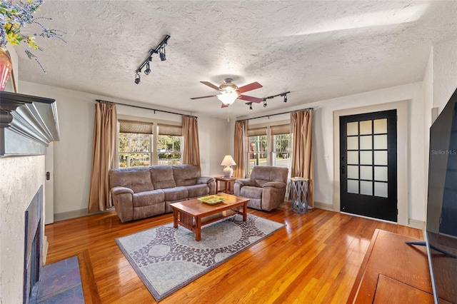 114 NE 11th Ave, Ocala, FL 34470 - living room with rail lighting, ceiling fan, and wood-type flooring