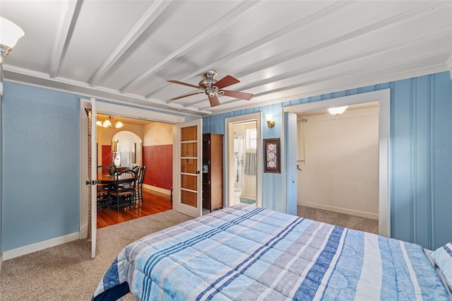 114 NE 11th Ave, Ocala, FL 34470 - carpeted bedroom with arched walkways, beam ceiling, a ceiling fan, a chandelier, and ensuite bathroom