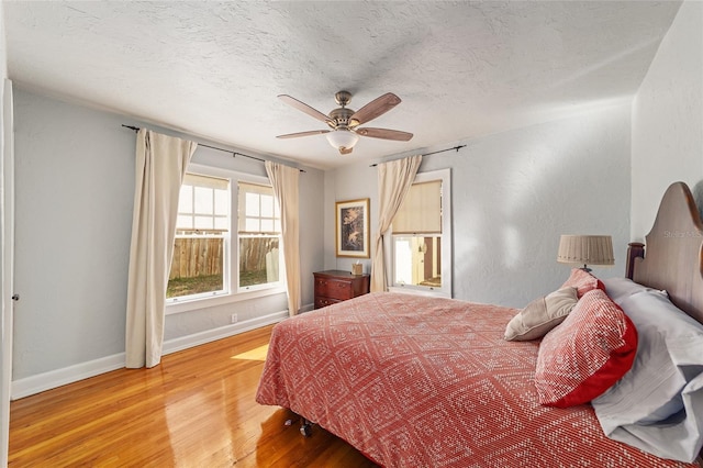 114 NE 11th Ave, Ocala, FL 34470 - bedroom with light wood-style flooring, a textured ceiling, and a ceiling fan
