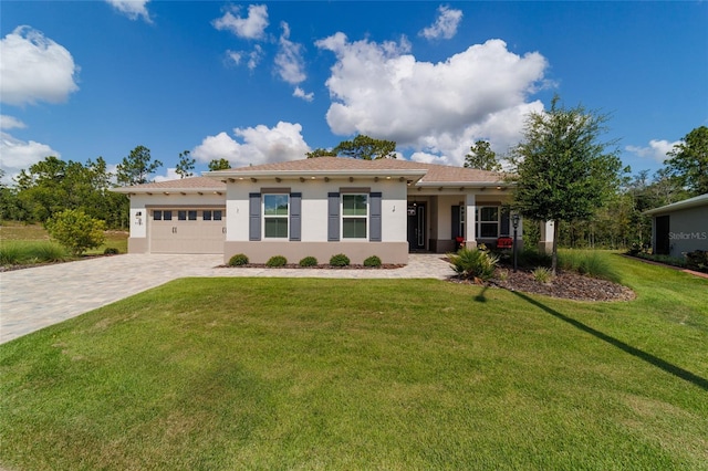 9746 SW 108th Terrace Rd, Ocala, FL 34481 - view of front of home with stucco siding, decorative driveway, an attached garage, and a front yard