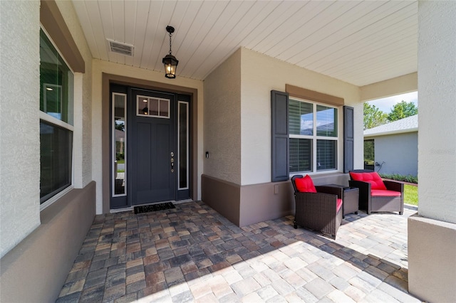 9746 SW 108th Terrace Rd, Ocala, FL 34481 - property entrance featuring stucco siding and outdoor lounge area
