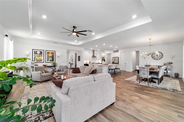 9746 SW 108th Terrace Rd, Ocala, FL 34481 - living area featuring a tray ceiling, wood finished floors, recessed lighting, a chandelier, and ornamental molding