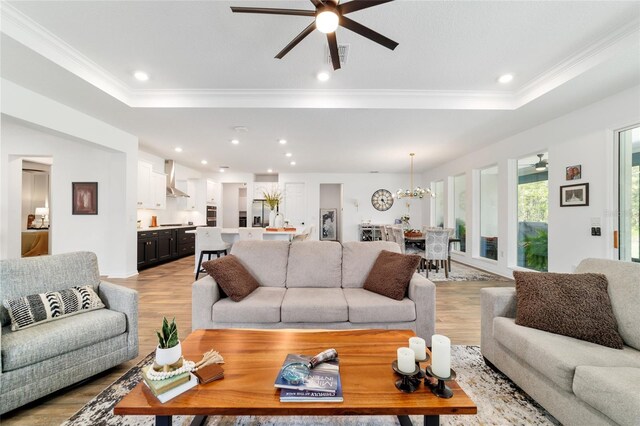 9746 SW 108th Terrace Rd, Ocala, FL 34481 - living room with a raised ceiling, a ceiling fan, crown molding, light wood finished floors, and recessed lighting