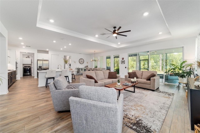 9746 SW 108th Terrace Rd, Ocala, FL 34481 - living room with a raised ceiling, ceiling fan, light wood-style floors, crown molding, and recessed lighting