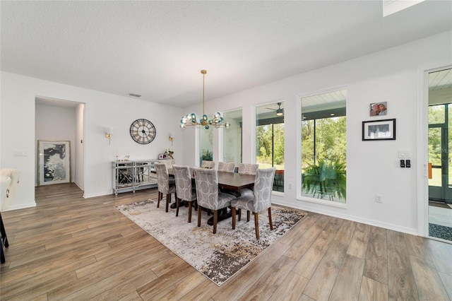 9746 SW 108th Terrace Rd, Ocala, FL 34481 - dining space featuring wood finished floors and a chandelier