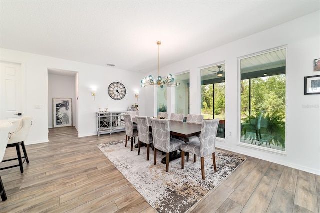 9746 SW 108th Terrace Rd, Ocala, FL 34481 - dining room featuring light wood-style floors and a chandelier