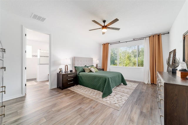 9746 SW 108th Terrace Rd, Ocala, FL 34481 - bedroom with light wood-style floors, a textured ceiling, ensuite bathroom, and a ceiling fan
