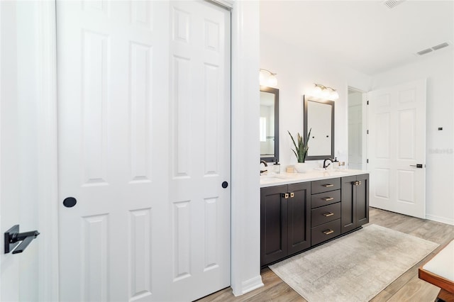 9746 SW 108th Terrace Rd, Ocala, FL 34481 - full bath with double vanity and wood finished floors