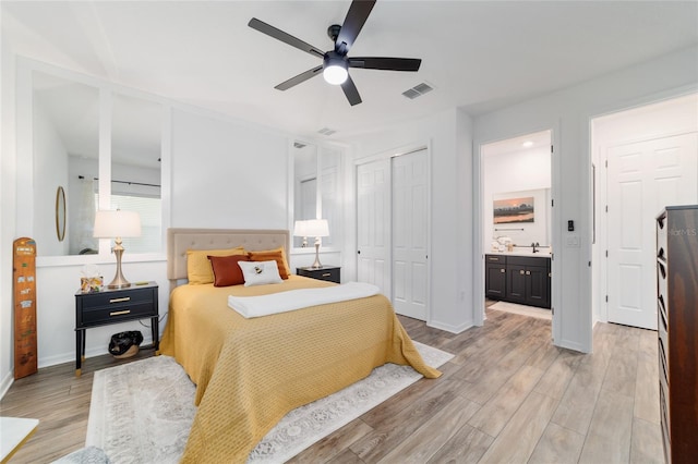 9746 SW 108th Terrace Rd, Ocala, FL 34481 - bedroom featuring light wood finished floors, a closet, ensuite bath, and a ceiling fan