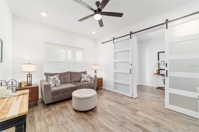 9746 SW 108th Terrace Rd, Ocala, FL 34481 - living room featuring a barn door, ceiling fan, light wood finished floors, and recessed lighting