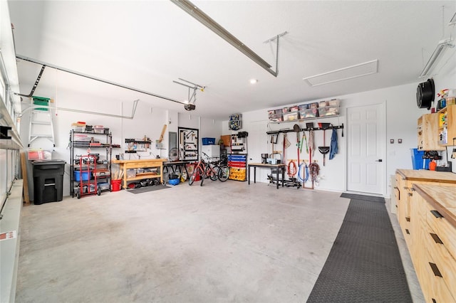 9746 SW 108th Terrace Rd, Ocala, FL 34481 - garage with a workshop area and a garage door opener