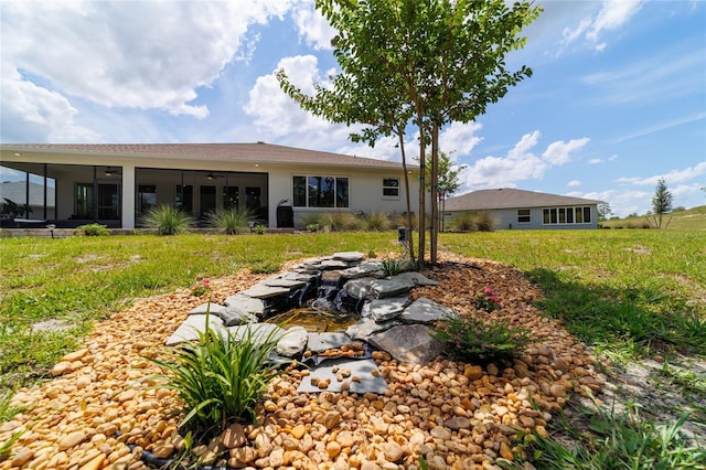 9746 SW 108th Terrace Rd, Ocala, FL 34481 - rear view of property with ceiling fan, a sunroom, a yard, and stucco siding