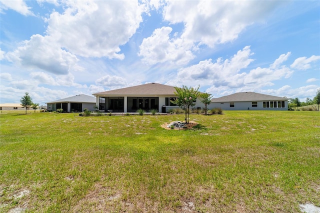 9746 SW 108th Terrace Rd, Ocala, FL 34481 - rear view of property featuring a sunroom and a lawn