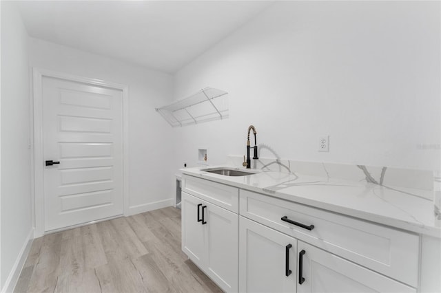 28 Water Track Dr, Ocala, FL 34472 - laundry room featuring washer hookup, cabinet space, and light wood-style floors