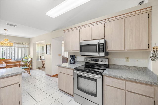 7443 SW 102nd Pl, Ocala, FL 34476 - kitchen featuring stainless steel appliances, light brown cabinetry, light countertops, light tile patterned floors, and pendant lighting