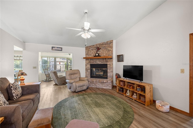 7443 SW 102nd Pl, Ocala, FL 34476 - living room featuring wood finished floors, a fireplace, a ceiling fan, and vaulted ceiling