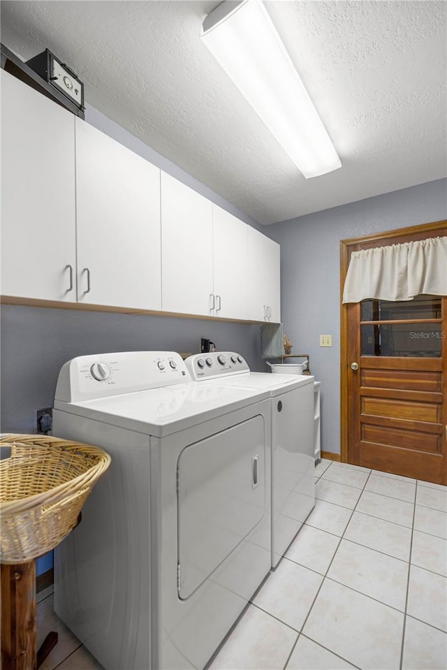 7443 SW 102nd Pl, Ocala, FL 34476 - washroom with washing machine and dryer, cabinet space, a textured ceiling, and light tile patterned floors