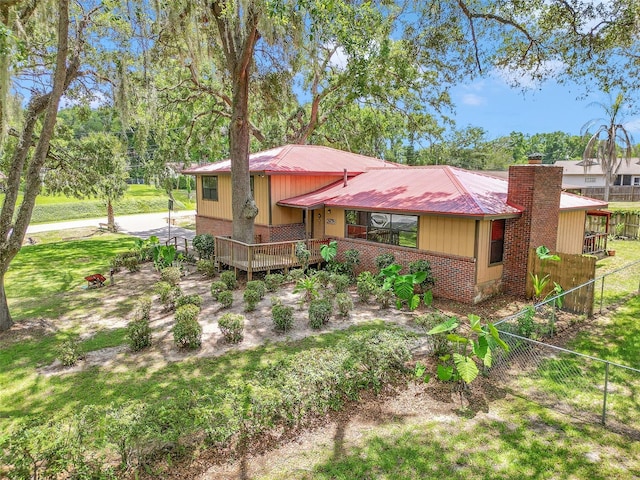 2676 SE 52nd Ave, Ocala, FL 34480 - view of front of home featuring a metal roof, a wooden deck, and brick siding