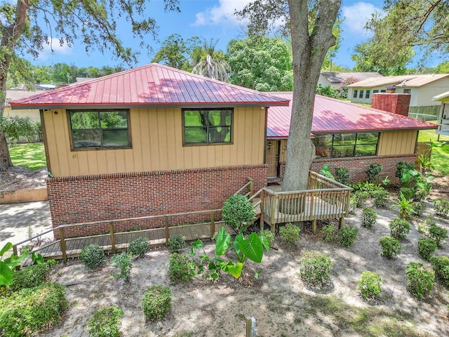 2676 SE 52nd Ave, Ocala, FL 34480 - view of front of house featuring brick siding, a metal roof, and a deck
