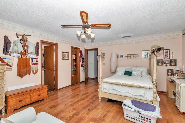 2676 SE 52nd Ave, Ocala, FL 34480 - bedroom with a textured ceiling, light wood-type flooring, and a ceiling fan