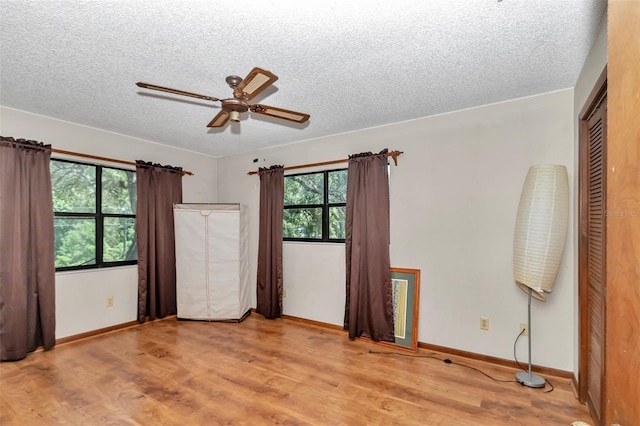 2676 SE 52nd Ave, Ocala, FL 34480 - unfurnished bedroom with a textured ceiling, wood finished floors, and a ceiling fan