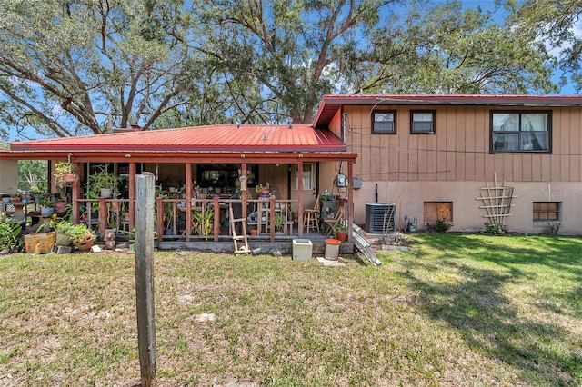 2676 SE 52nd Ave, Ocala, FL 34480 - rear view of property featuring a lawn, a metal roof, and a patio area