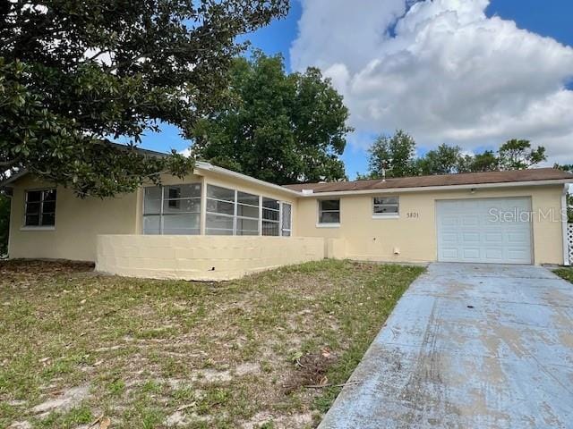 3801 SW 147th Lane Rd, Ocala, FL 34473 - view of front of home with stucco siding, concrete driveway, and an attached garage