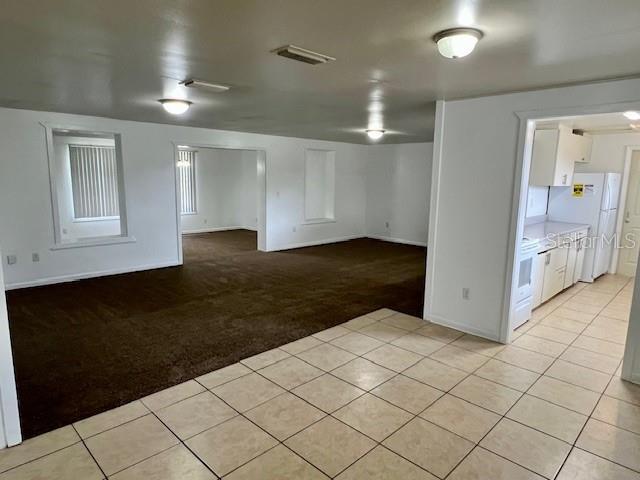 3801 SW 147th Lane Rd, Ocala, FL 34473 - unfurnished room with light tile patterned flooring and light colored carpet