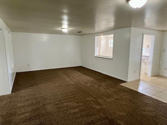 3801 SW 147th Lane Rd, Ocala, FL 34473 - spare room featuring carpet flooring and tile patterned flooring