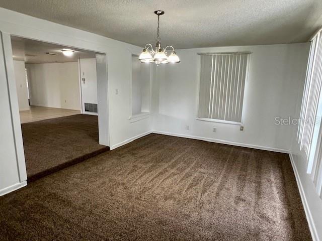 3801 SW 147th Lane Rd, Ocala, FL 34473 - empty room featuring dark colored carpet, a textured ceiling, and a chandelier