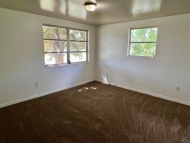3801 SW 147th Lane Rd, Ocala, FL 34473 - empty room featuring dark colored carpet and baseboards