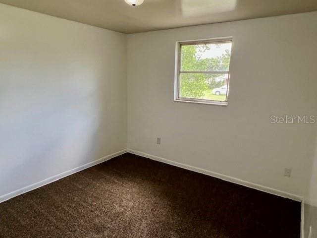 3801 SW 147th Lane Rd, Ocala, FL 34473 - empty room featuring dark colored carpet and baseboards
