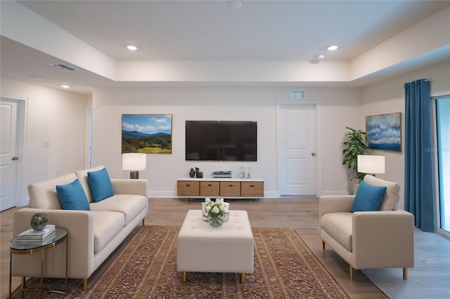 2858 W Camilo Dr, Citrus Springs, FL 34434 - living area featuring light wood-style floors, recessed lighting, and a raised ceiling