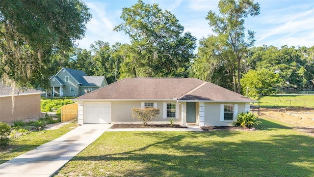 5596 NW 57th St, Ocala, FL 34482 - single story home with stucco siding, an attached garage, driveway, and view of wooded area