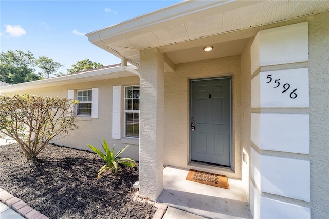 5596 NW 57th St, Ocala, FL 34482 - doorway to property with stucco siding